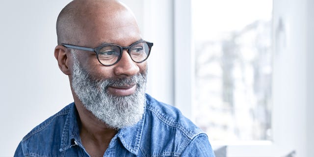 Happy Man Staring Out of Window